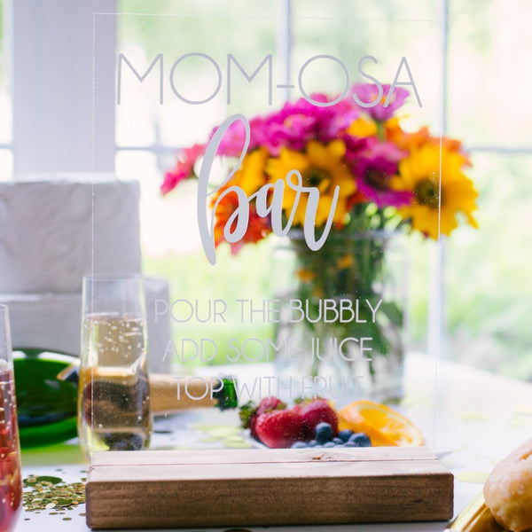 http://richdesignco.com/cdn/shop/products/mom-osa-bar-baby-shower-clear-acrylic-mimosa-bar-sign-927223_grande.jpg?v=1662502355